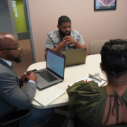 A mentor at a business incubator helping a small business owner draft an early-stage business model.