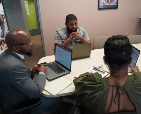A mentor at a business incubator helping a small business owner draft an early-stage business model.